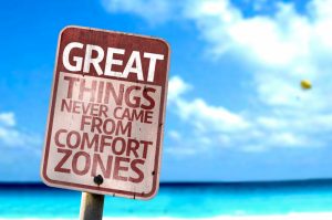 a sign of great things never came from comfort zones with a beach on the background