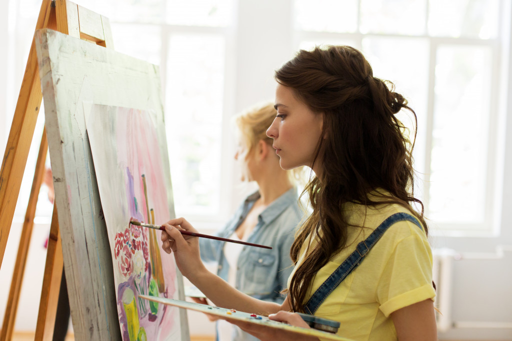 A woman in a studio doing painting class
