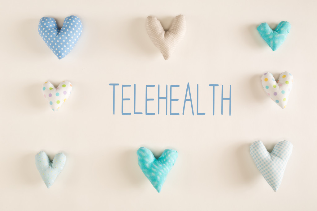 TELEHEALTH word on background with heart cushions
